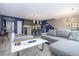 Open floor plan with grey sectional sofa and kitchen view at 4410 Le Reve Ct, Kissimmee, FL 34746