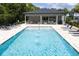 Refreshing community pool with water features and lounge chairs at 4410 Le Reve Ct, Kissimmee, FL 34746