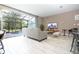 Bright living room with sliding glass doors to screened lanai and pool at 4410 Le Reve Ct, Kissimmee, FL 34746