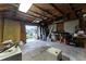 Unfinished garage with tools, storage, and open door at 4908 Seminole Ave, Winter Park, FL 32792