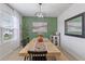 Dining room with a farmhouse table and green accent wall at 740 Squires Grove Dr, Winter Haven, FL 33880