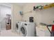 Laundry room with washer, dryer, utility sink, and shelving at 8460 Karwick St, Orlando, FL 32836