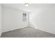 Bright bedroom with grey carpet and a window at 1325 Oak Valley Dr, Auburndale, FL 33823