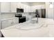 Modern kitchen with white cabinets, quartz countertops, and stainless steel appliances at 1541 Heritage Pl, Oviedo, FL 32765