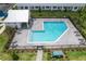 Community pool with a L-shape design, a pergola, and plenty of lounge chairs at 1541 Heritage Pl, Oviedo, FL 32765