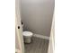 Clean bathroom with wood-look tile floor, white toilet and vanity, and marble shower surround at 1554 Outback W Rd, St Cloud, FL 34771