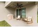 Covered patio with ceiling fan, and comfortable seating for relaxation at 1554 Outback W Rd, St Cloud, FL 34771