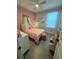 Charming bedroom with pink bedding and a canopy bed at 1554 Outback W Rd, St Cloud, FL 34771