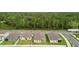 Aerial view showcasing a row of houses with backyard privacy and a wooded backdrop at 1554 Outback W Rd, St Cloud, FL 34771