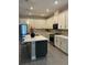 Modern kitchen with white cabinets, quartz countertops, and stainless steel appliances at 1554 Outback W Rd, St Cloud, FL 34771