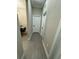 Bright hallway with wood-look tile floors and neutral-colored walls at 1554 Outback W Rd, St Cloud, FL 34771