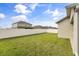 Large backyard with a private white fence and lush green grass at 1554 Outback W Rd, St Cloud, FL 34771