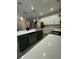 Modern kitchen island with white cabinets, quartz countertops and stainless steel appliances at 1554 Outback W Rd, St Cloud, FL 34771