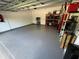 Garage with epoxy flooring, ample storage shelving, and overhead storage at 1554 Outback W Rd, St Cloud, FL 34771