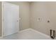 Simple laundry room with tile floor and access to additional storage at 1703 Daybreak Dr, Fruitland Park, FL 34731