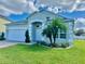 One-story house with a two-car garage, and a palm tree in the front yard at 267 Doe Run Dr, Winter Garden, FL 34787