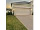 Two-car garage with a white door at 267 Doe Run Dr, Winter Garden, FL 34787