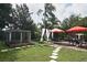 Landscaped backyard with patio, garden, and relaxing seating areas at 350 Velveteen Pl, Chuluota, FL 32766