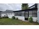 Enclosed patio/sunroom addition with a white exterior and black trim at 370 Chicago Woods Cir, Orlando, FL 32824