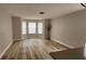 Bright living room with bay windows and wood-look flooring at 370 Chicago Woods Cir, Orlando, FL 32824