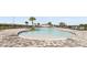 Community pool with lounge chairs and shade structures at 3813 Giorgio Dr, Winter Haven, FL 33884