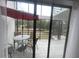 Screened patio with table and chairs, offering a view of the backyard at 4559 Tower Pine Rd # Ge, Orlando, FL 32839