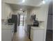 Modern white kitchen with stainless steel appliances at 4559 Tower Pine Rd # Ge, Orlando, FL 32839