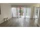 Living room with grey vinyl plank flooring and access to deck at 4559 Tower Pine Rd # Ge, Orlando, FL 32839