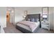 Well-lit bedroom with gray carpeting and large window at 1258 Limbali St, Mount Dora, FL 32757