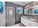 Double vanity bathroom with gray walls and ocean-themed decor at 2734 Oxymoron Way, Kissimmee, FL 34746