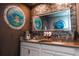 Bathroom with double vanity, porthole mirrors, and sea turtle mural at 2734 Oxymoron Way, Kissimmee, FL 34746