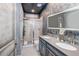 Bathroom with double vanity, walk-in shower, and gray decor at 2734 Oxymoron Way, Kissimmee, FL 34746