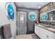 Double vanity bathroom with gray walls and ocean-themed decor at 2734 Oxymoron Way, Kissimmee, FL 34746