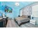 Bedroom with king-size bed, ocean-themed decor, and TV at 2734 Oxymoron Way, Kissimmee, FL 34746