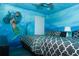 Bedroom with twin beds and mermaid wall art at 2734 Oxymoron Way, Kissimmee, FL 34746