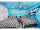 Twin beds in a bedroom featuring an ocean mural at 2734 Oxymoron Way, Kissimmee, FL 34746