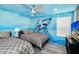 Bedroom with twin beds and ocean-themed mural at 2734 Oxymoron Way, Kissimmee, FL 34746