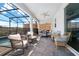 Relaxing covered patio with seating area, adjacent to the pool and outdoor kitchen at 2734 Oxymoron Way, Kissimmee, FL 34746