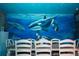 Dining room with white table and chairs, ocean mural at 2734 Oxymoron Way, Kissimmee, FL 34746