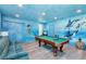 Game room with pool table and ocean-themed murals at 2734 Oxymoron Way, Kissimmee, FL 34746