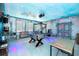 Game room with foosball, arcade games, and colorful lighting at 2734 Oxymoron Way, Kissimmee, FL 34746