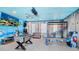Game room with foosball table, arcade games, and ocean-themed decor at 2734 Oxymoron Way, Kissimmee, FL 34746