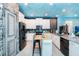 Modern kitchen with island, stainless steel appliances, and ocean-themed decor at 2734 Oxymoron Way, Kissimmee, FL 34746