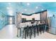 Modern kitchen with stainless steel appliances and a breakfast bar, featuring a unique ocean-themed mural at 2734 Oxymoron Way, Kissimmee, FL 34746