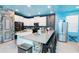 Modern kitchen with island, stainless steel appliances, and painted ceiling at 2734 Oxymoron Way, Kissimmee, FL 34746