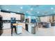 Open concept kitchen with island, stainless steel appliances, and ocean-themed murals at 2734 Oxymoron Way, Kissimmee, FL 34746