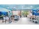 Ocean-themed living room with gray sofa and large TV at 2734 Oxymoron Way, Kissimmee, FL 34746