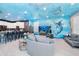 Open living space with ocean mural and kitchen at 2734 Oxymoron Way, Kissimmee, FL 34746
