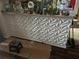 Kitchen features unique geometric 3D wall decor and dark wood flooring at 345 Reserve Dr, Davenport, FL 33896