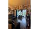 Living room with dark wood floors, sliding glass doors to a pool, and black reclining sofas at 345 Reserve Dr, Davenport, FL 33896